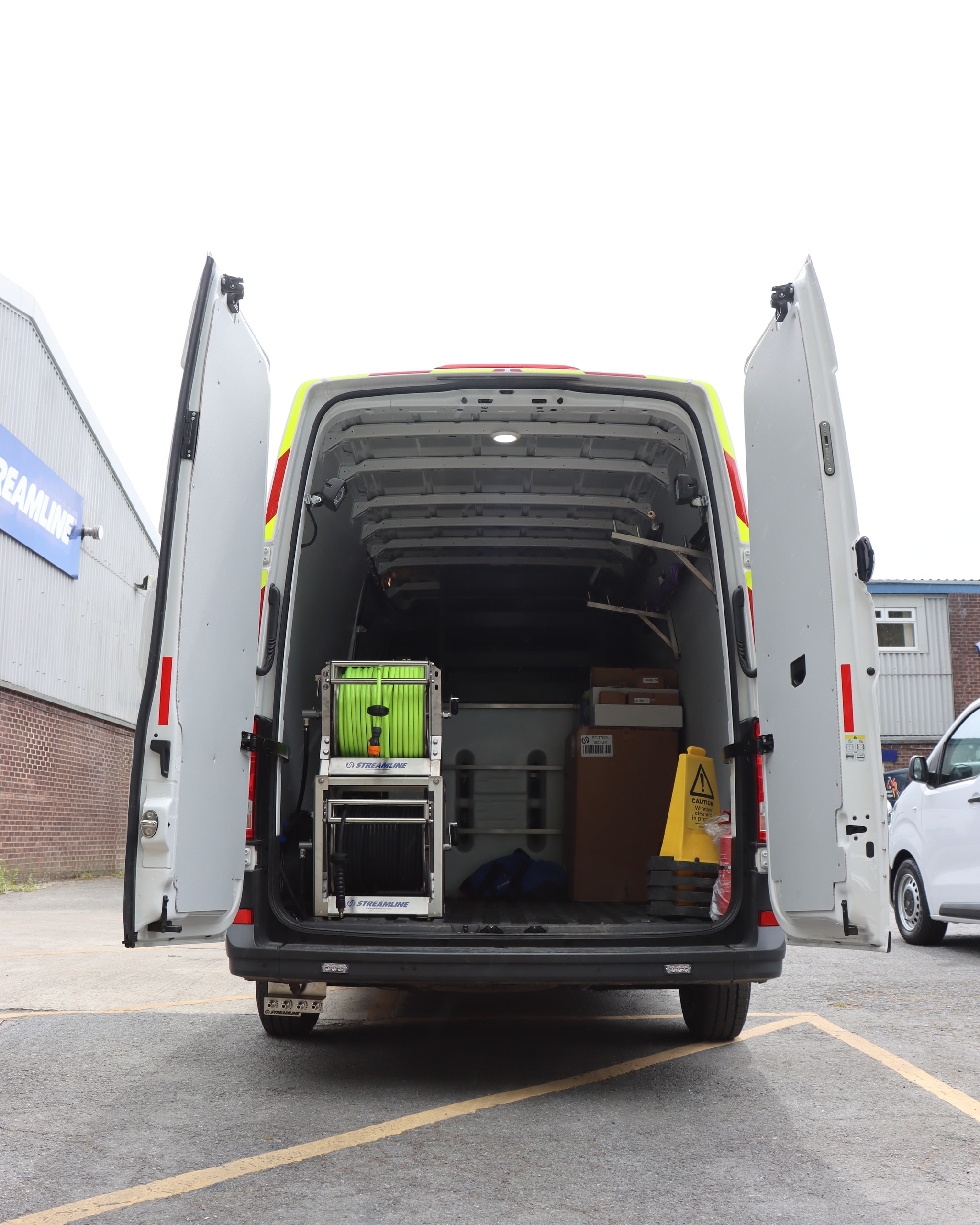 Van rear fitout with stacked Streamline hose reels and Honda pressure washer