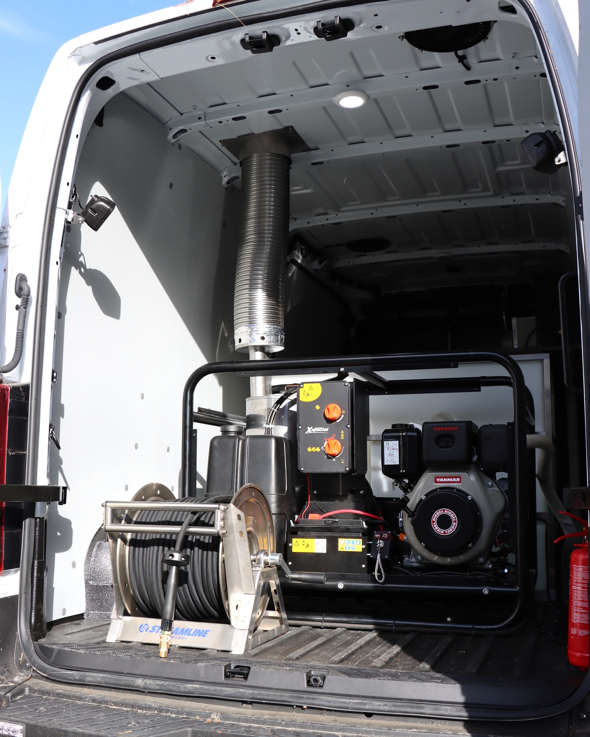 Diesel Yanmar pressure washer, exhaust and stainless hose reel in a van