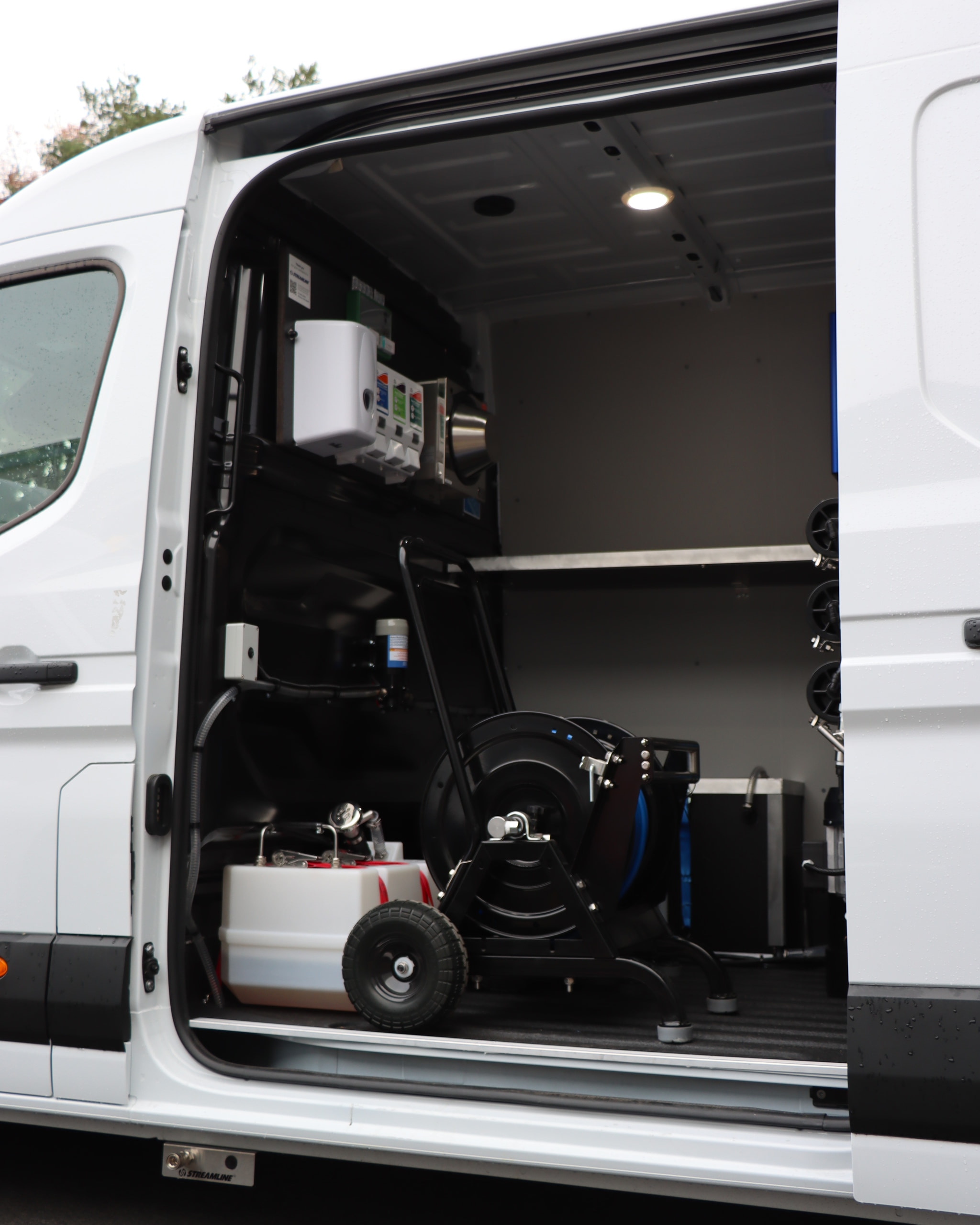 Side-door specialist cleaning van with chemical station, tank and hose reel trolley