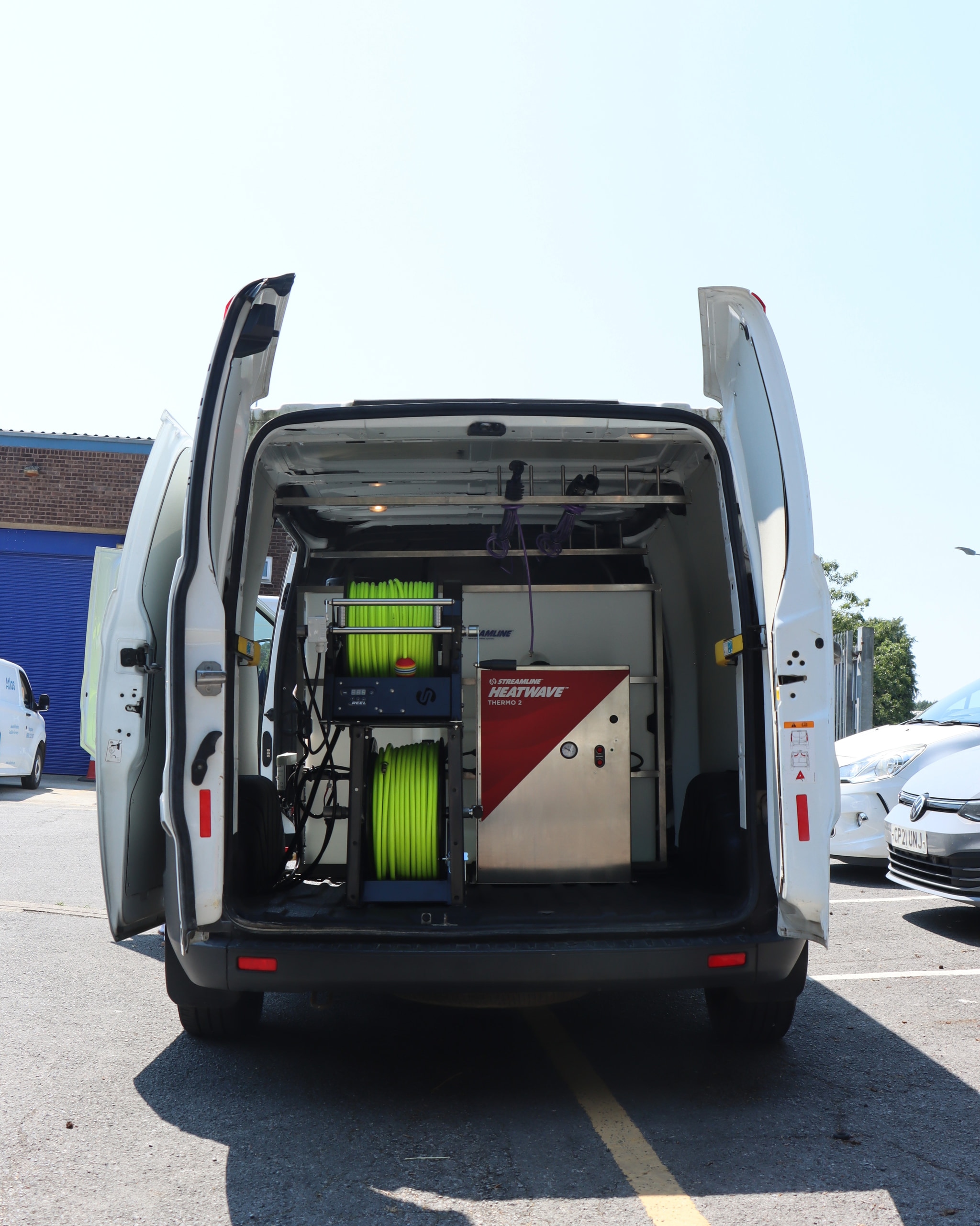 Bespoke window cleaning van interior with hose reels, Heatwave Thermo 2 and water-fed pole racks